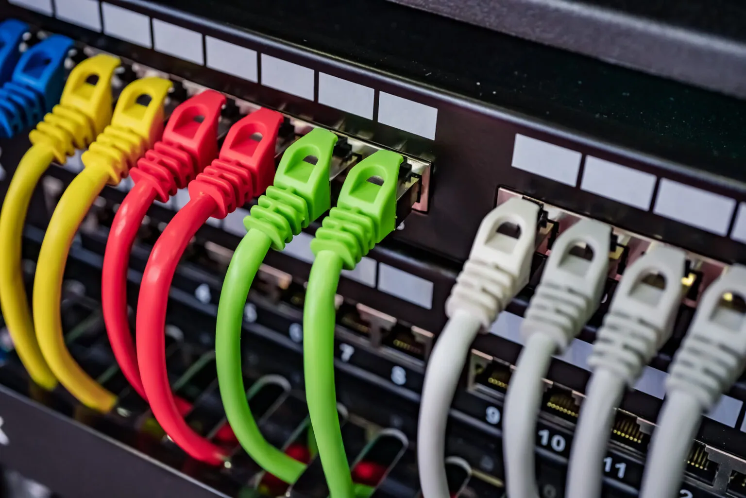 Close-up of colorful network cabling and wires plugged into a switch or patch panel, highlighting security and connectivity.